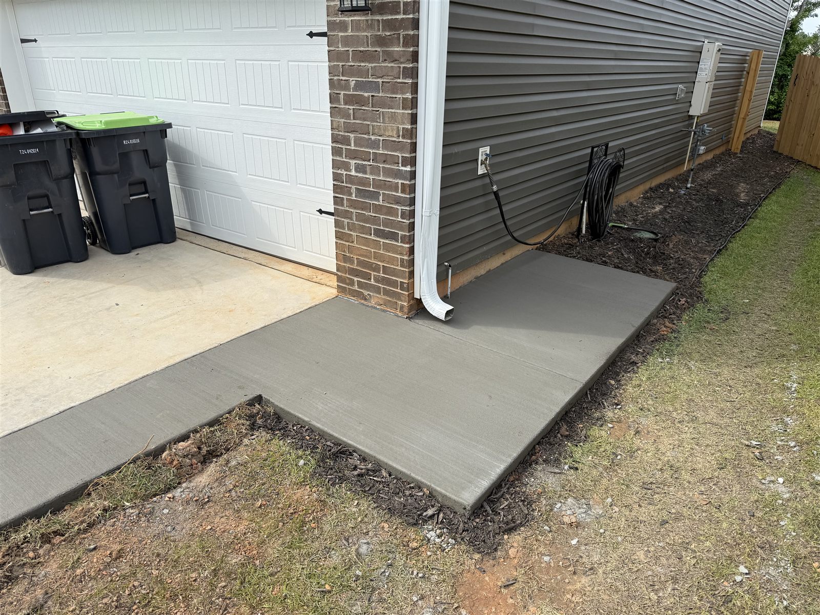 Concrete pad poured beside a garage and driveway, Columbia SC